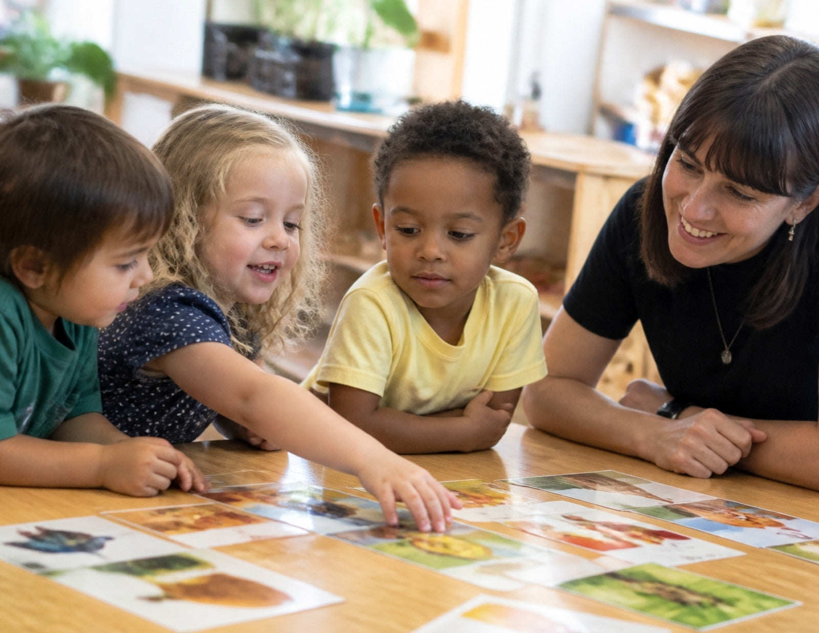 Teacher and children working with picture cards in a small group